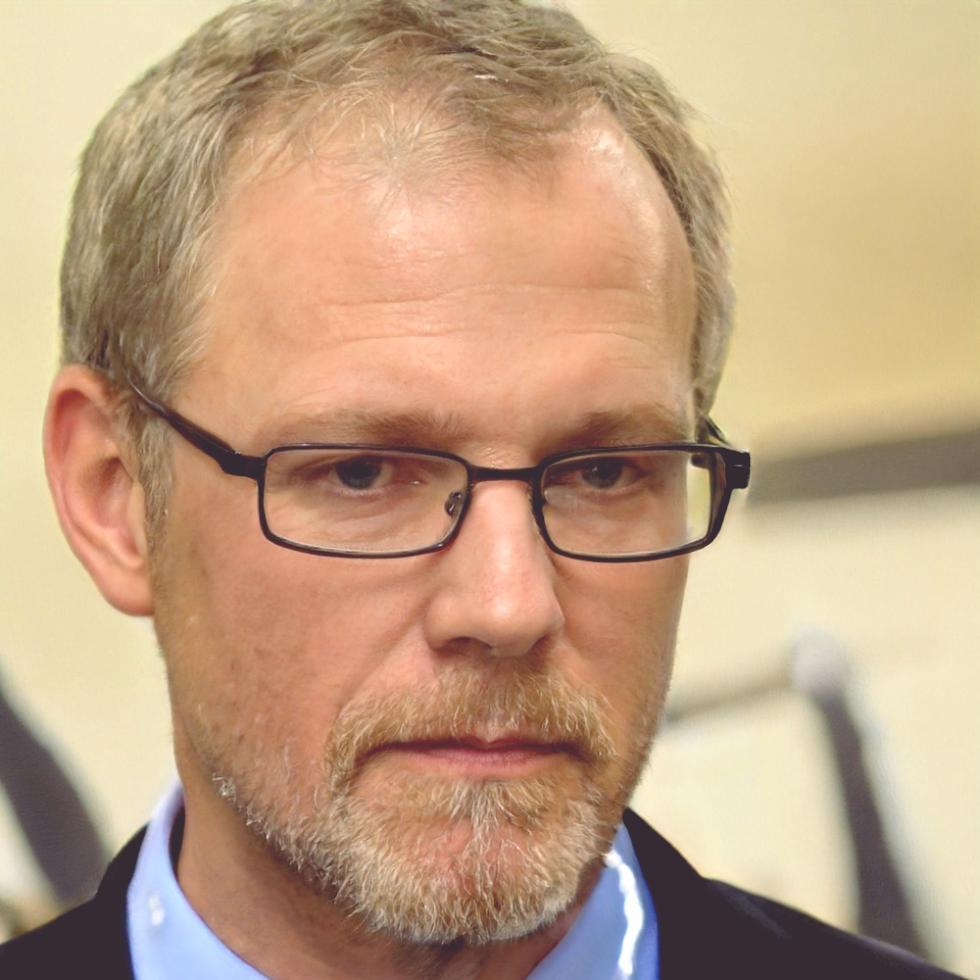 Professional headshot of financial expert