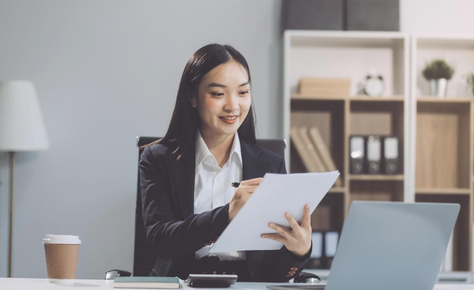 Business executive analyzing comprehensive financial dashboards on multiple screens showing integrated performance metrics and predictive models